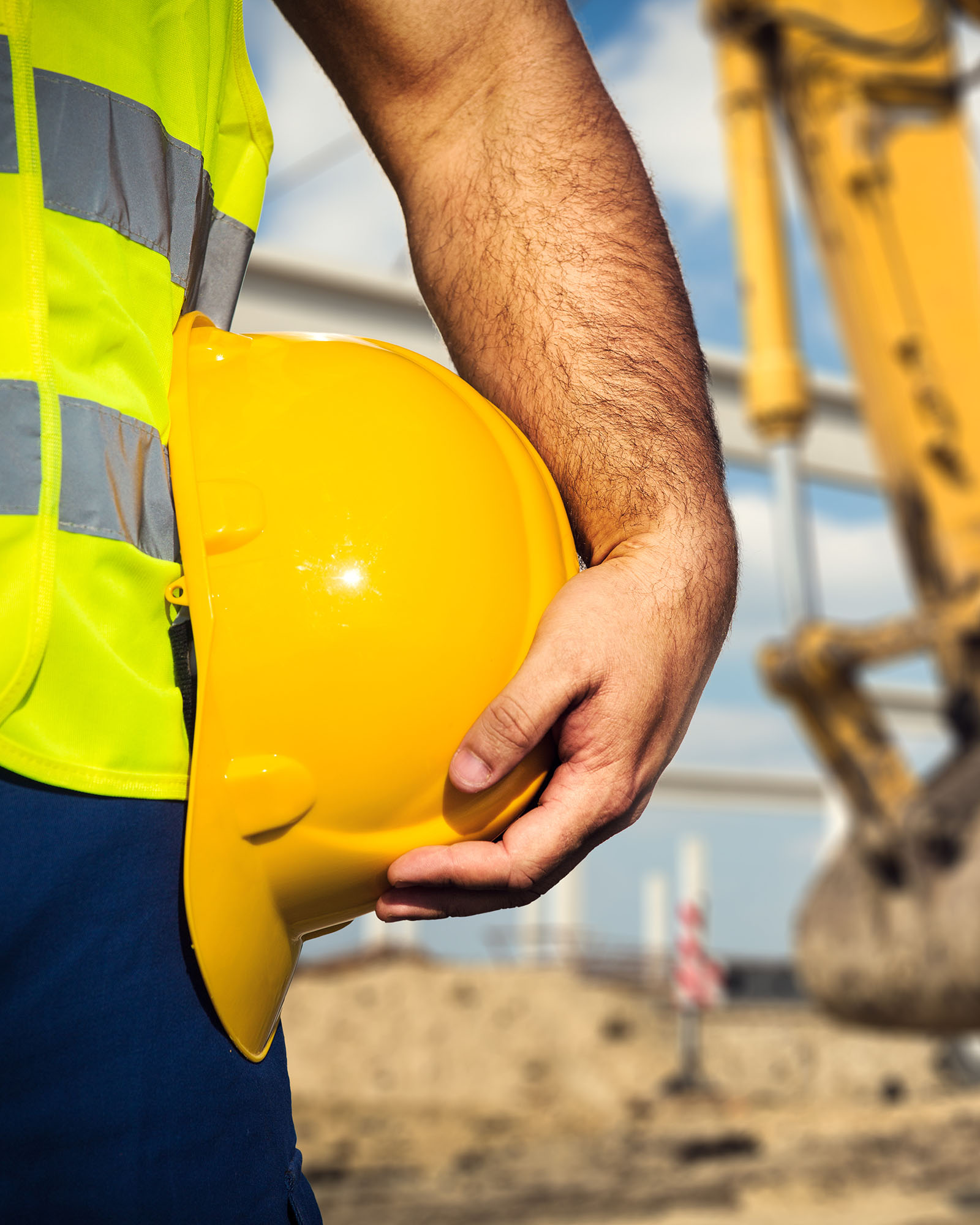 construction worker holding hat representing construction management at risk CMAR project delivery method